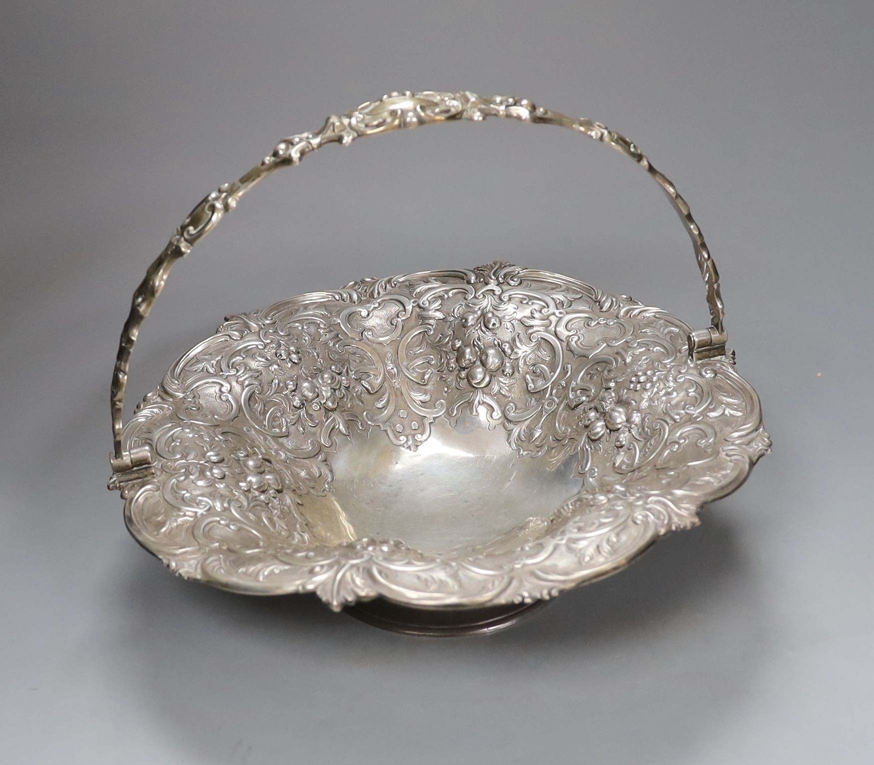 A Victorian Scottish silver fruit basket, embossed with fruit amid scrolls, MS&B, Glasgow, 1861, diameter 32.2cm, 34oz (repairs).